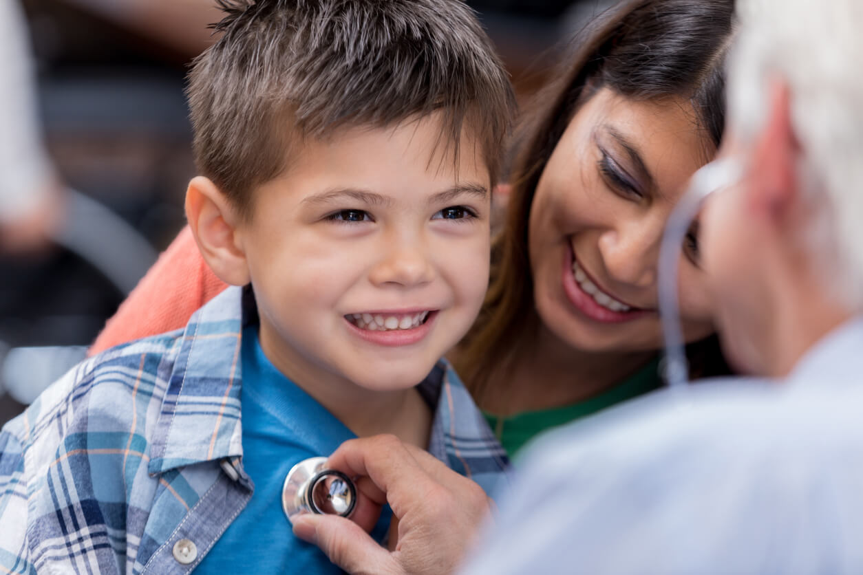 Doctor examines young patient during well check