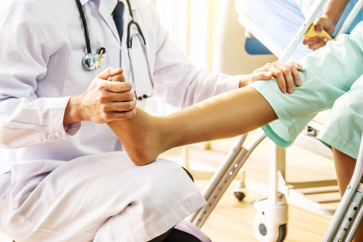 orthopedic Doctor examining of the leg from the knee and ankle