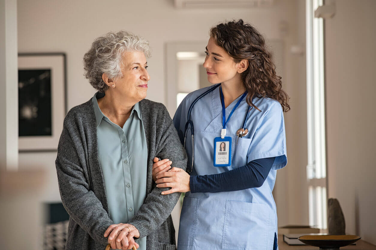 Caregiver assist senior woman at walk in clinic