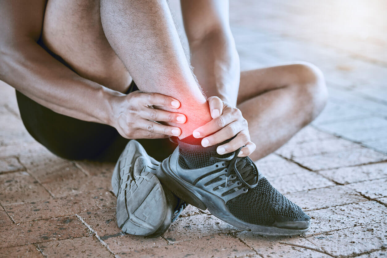 A runner with swollen ankle pain from a sprained ankle or a fracture.